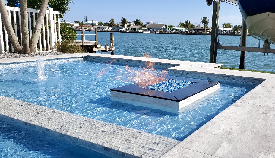 Modern waterfront swimming pool with fire feature